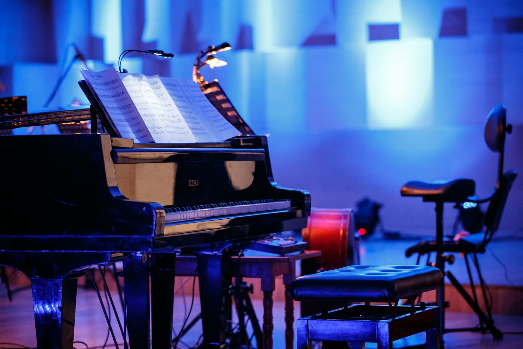 Grand piano against a blue wall
